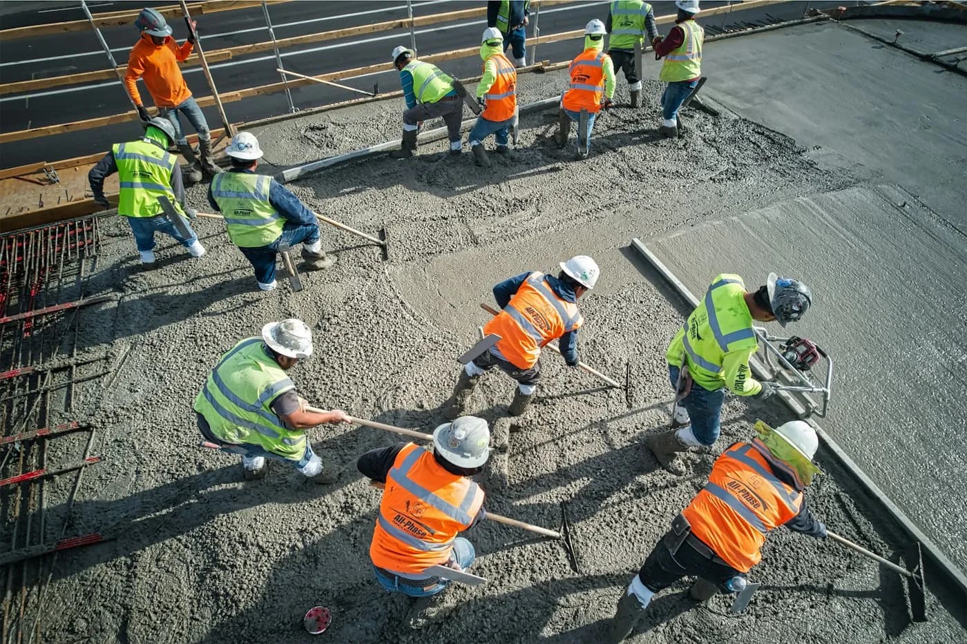 Construction workers levelling concrete at a building site