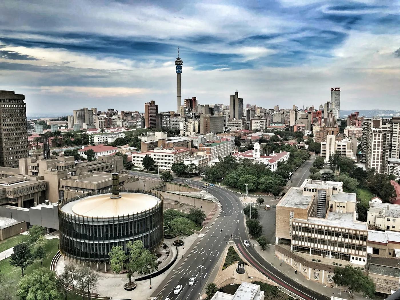 Johannesburg city centre, with roads and tall buildings beneath a cloudy sky